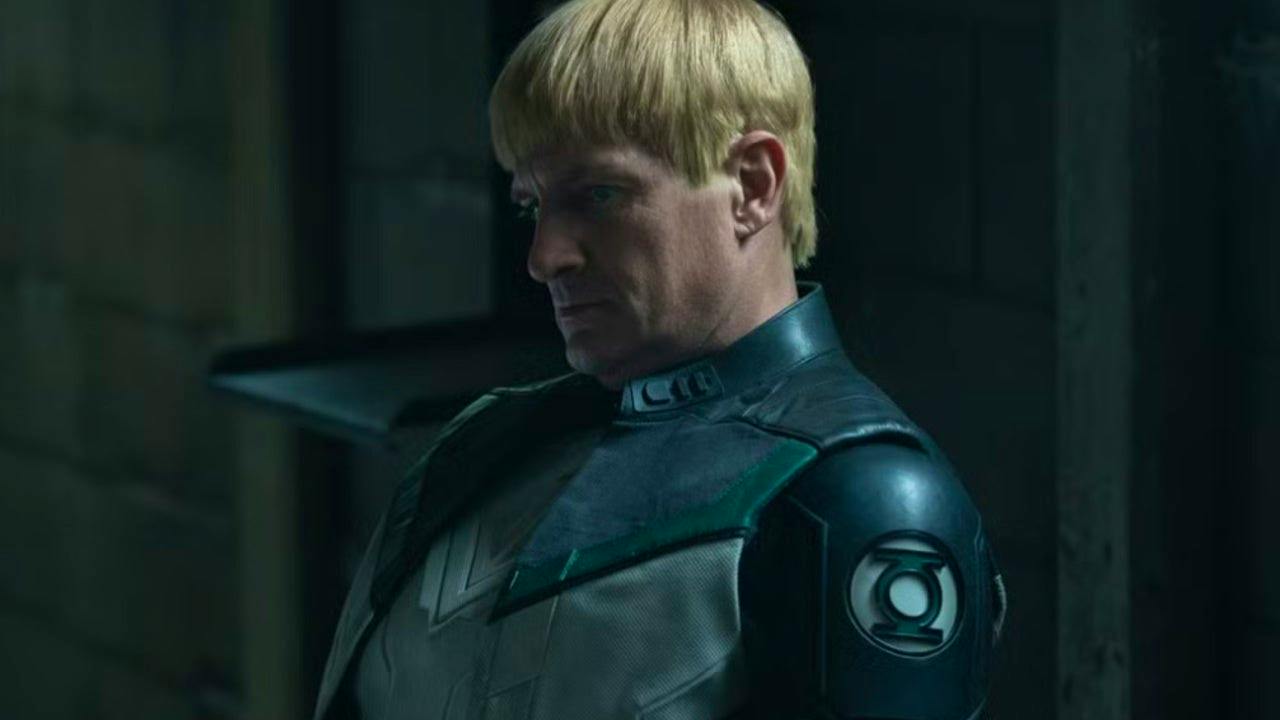 Guy Gardner sitting in the shadows, looking serious